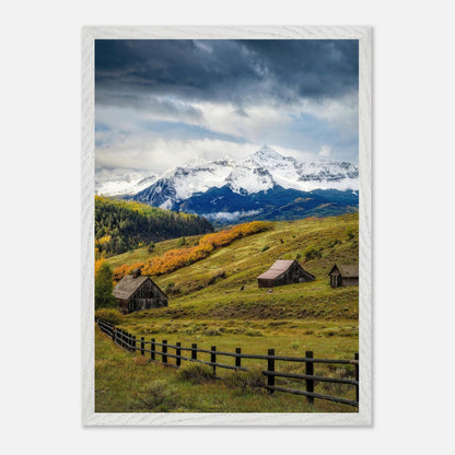 Framed Giclée fine art print of rustic barns and snow-capped mountains in Telluride, Colorado, showcasing natural beauty.