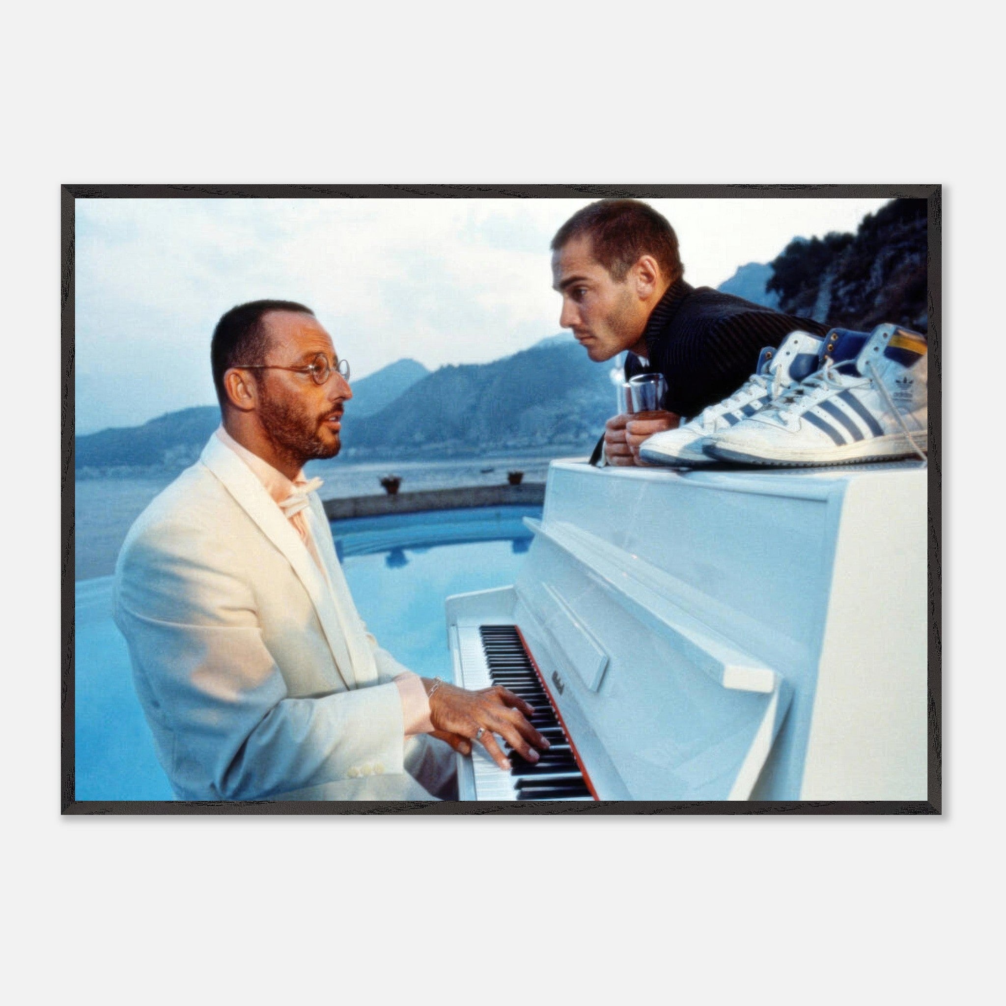 Jean Reno Piano Fine Art Print featuring a poolside performance with a coastal backdrop, capturing cinematic elegance.