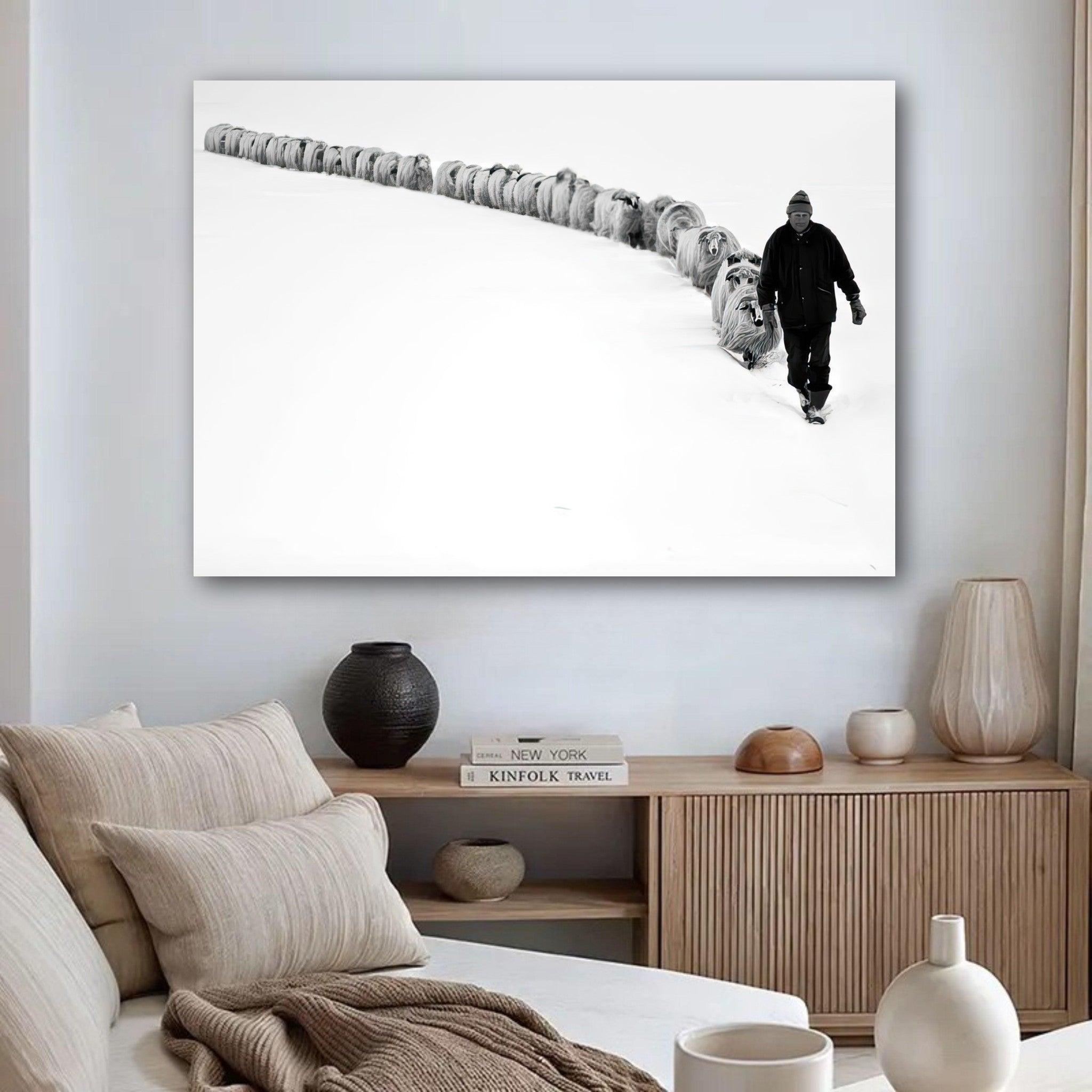Shepherd guiding flock through a snow-covered landscape in black-and-white poster, depicting resilience and harmony.