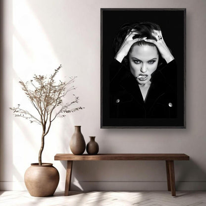 Vintage framed print of Angelina Jolie exuding charisma and attitude in a black-and-white style. Ideal for art lovers.