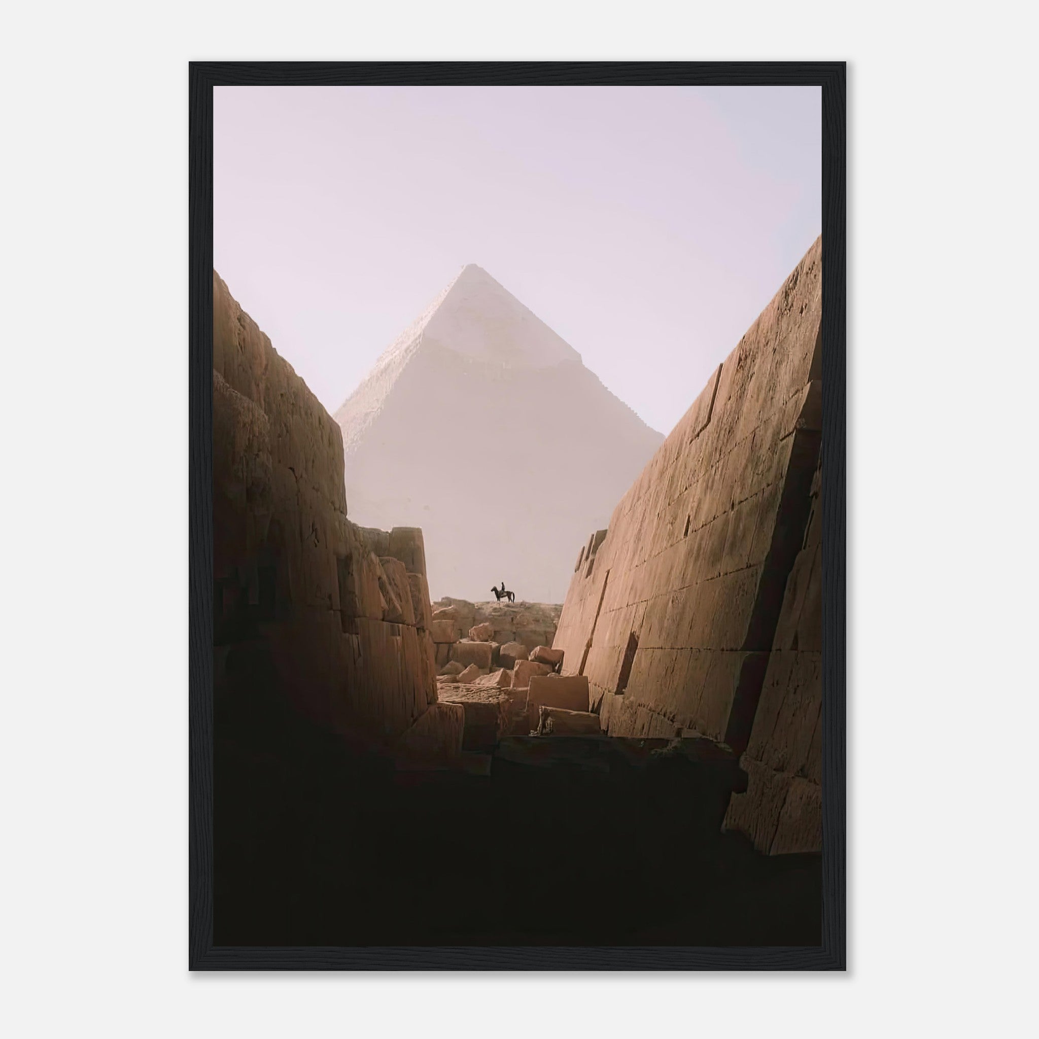 Framed print of a rider on horseback silhouetted against the Great Pyramid of Giza, framed by ancient stone walls.