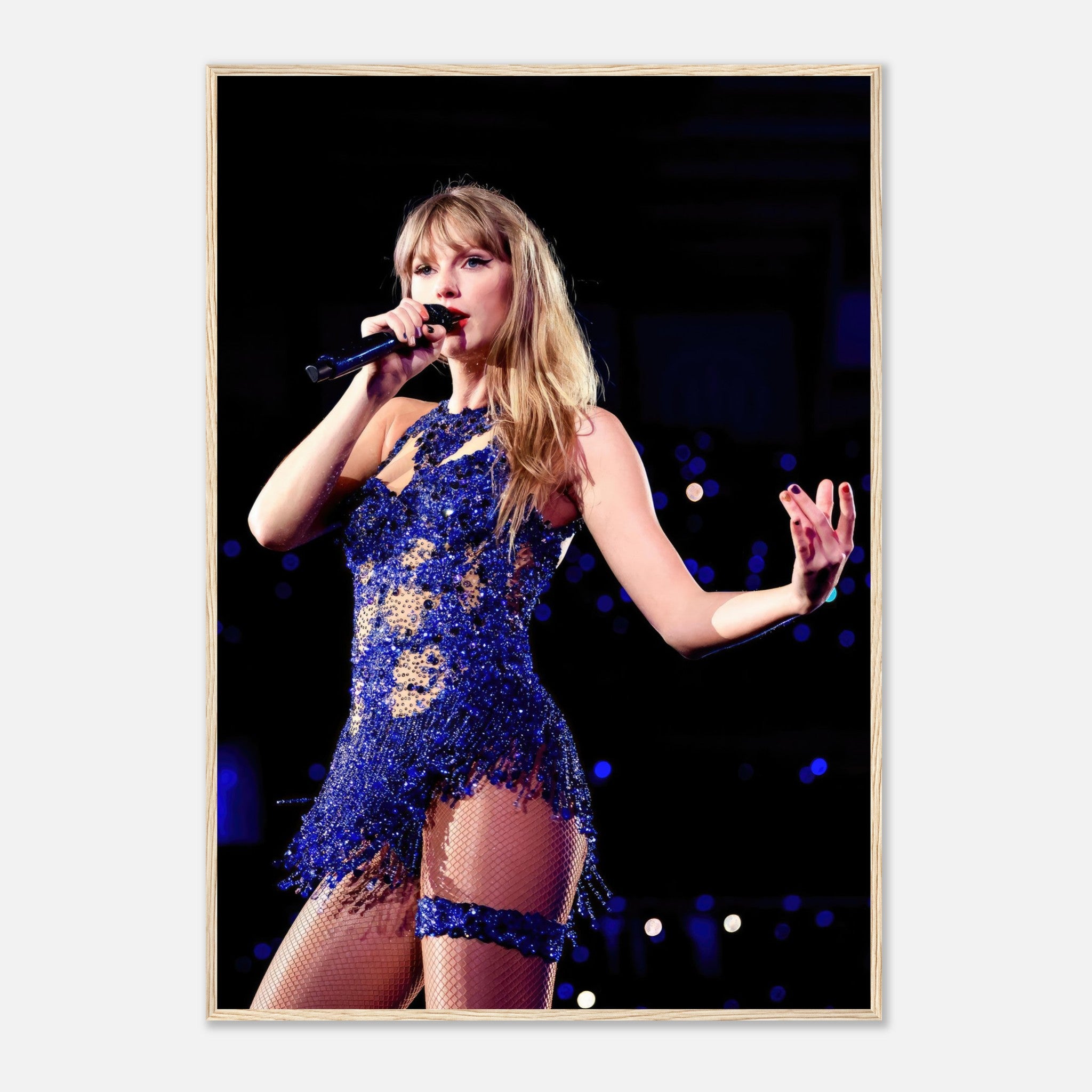 Taylor Swift performing live in a sparkling blue outfit, captured in a stunning framed print for fans and music lovers.