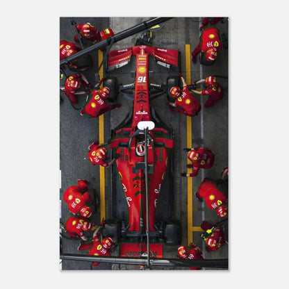 Formula 1 Ferrari pitstop in action, showcasing vibrant colors and team dynamics on a metal print.