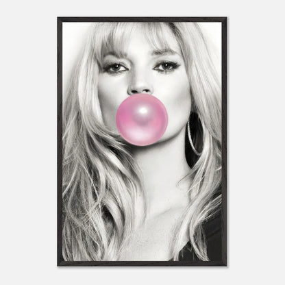 Vintage framed print of Kate Moss blowing pink bubble gum in black-and-white, adding a whimsical touch to any decor.