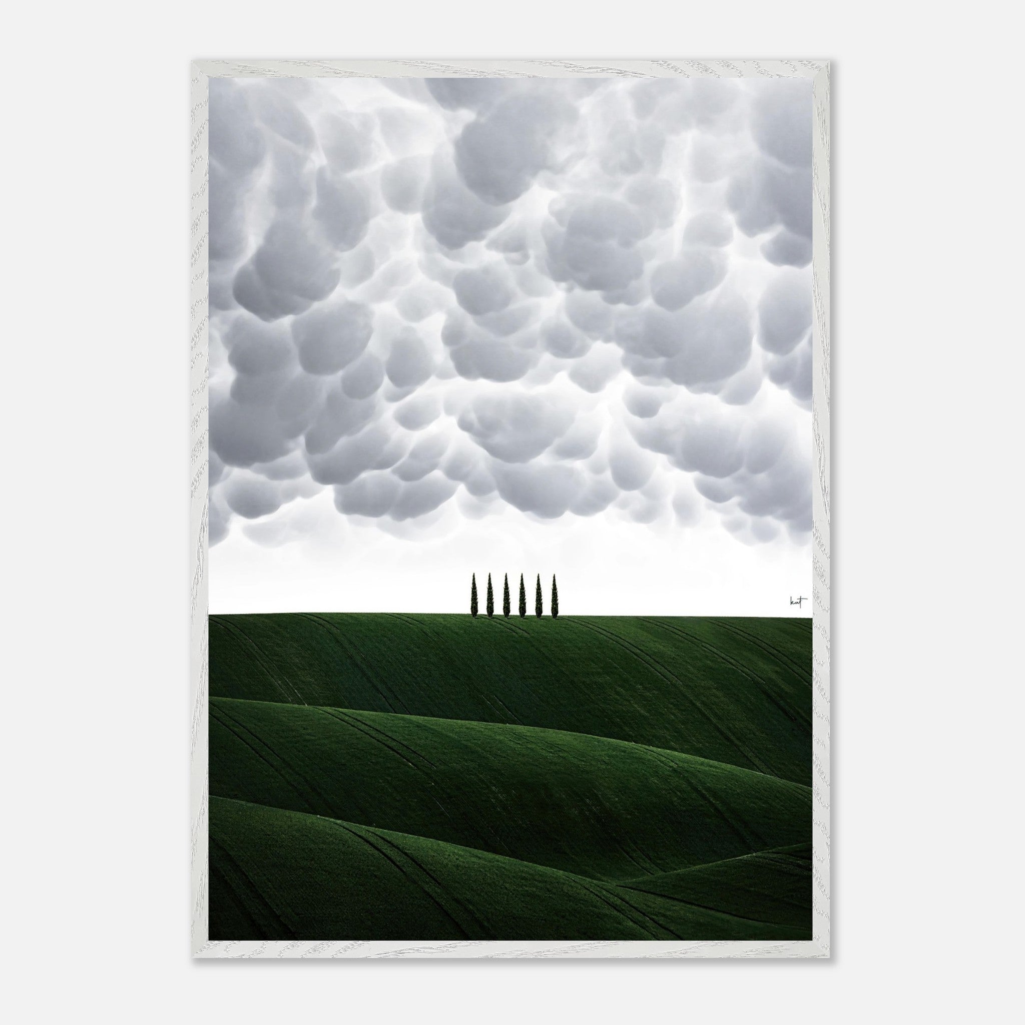 Vintage framed art of Tuscan hills with cypress trees under a dramatic cloud-filled sky.