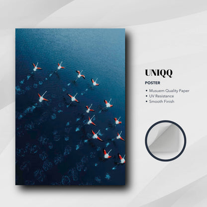 Flamingos Drone Photography Poster featuring a flock gliding over blue water, showcasing vibrant colors and elegant design.