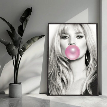 Vintage framed print of Kate Moss blowing pink bubble gum in a modern interior setting.