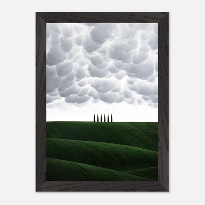 Vintage framed art of Tuscan hills with cypress trees under a dramatic sky, capturing Italy's serene landscape.