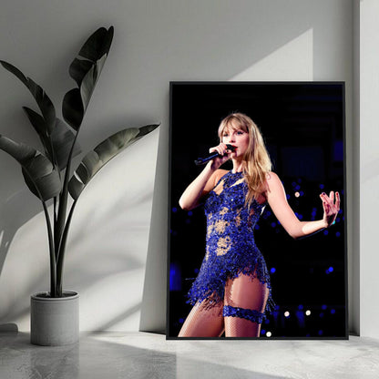 Taylor Swift framed print featuring her in a dazzling blue outfit during a live performance, perfect for music fans.