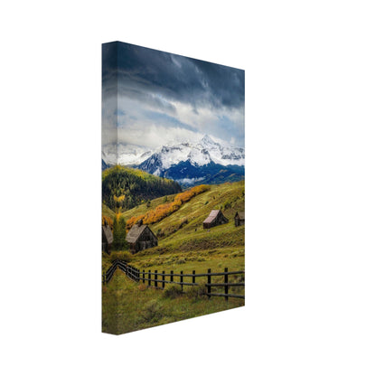 Telluride, Colorado canvas artwork featuring rustic cabins and stunning snow-capped peaks amidst autumn foliage.