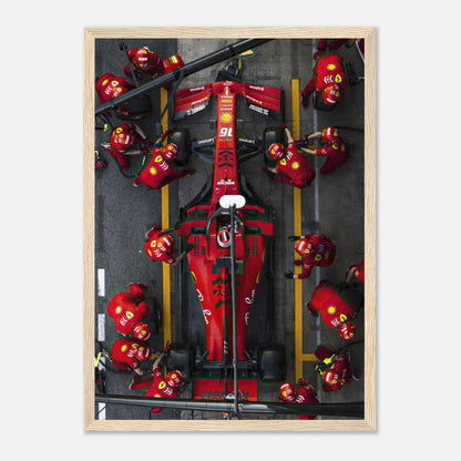 Formula 1 Ferrari pitstop framed print showcasing dynamic pit crew action and vivid red colors. Perfect for motorsport enthusiasts.