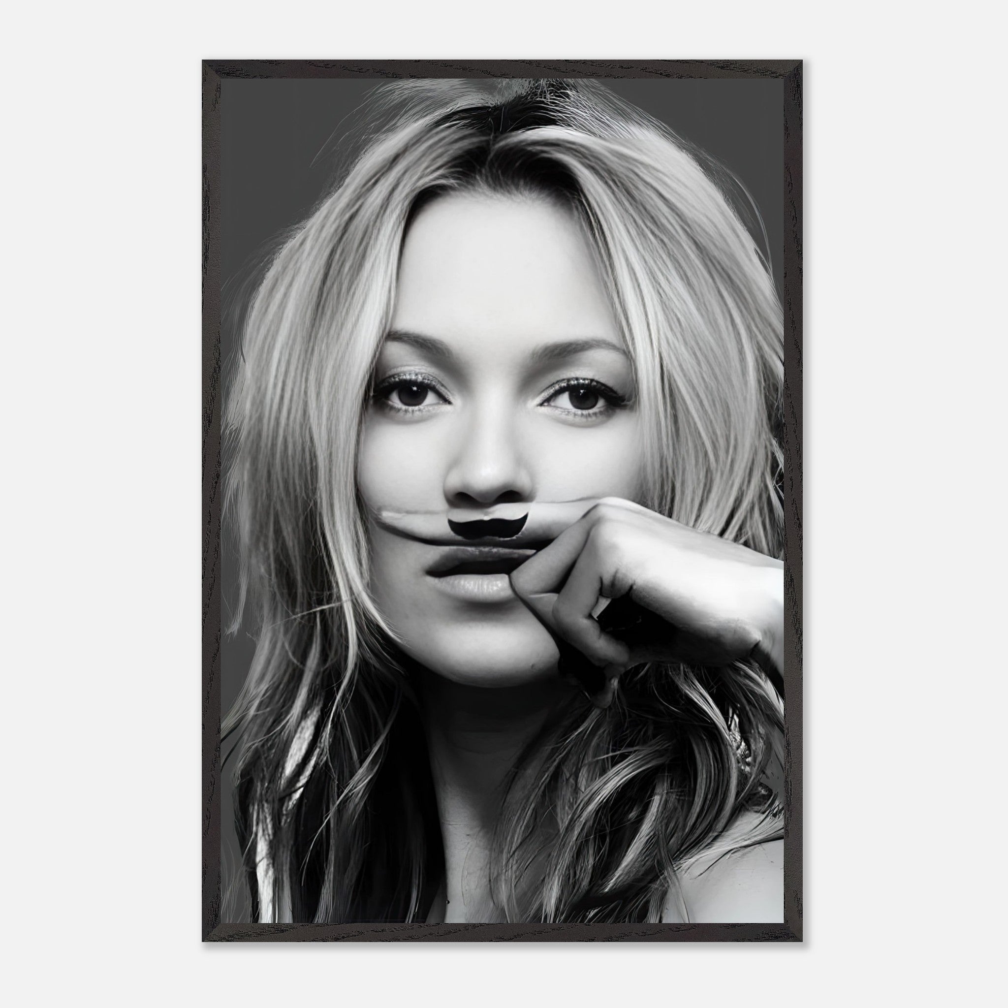 Vintage framed print of Kate Moss with a playful mustache, capturing high fashion and humor in black and white.