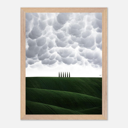 Toscana Vintage Framed Art featuring rolling green hills and cypress trees under a dramatic cloudy sky.