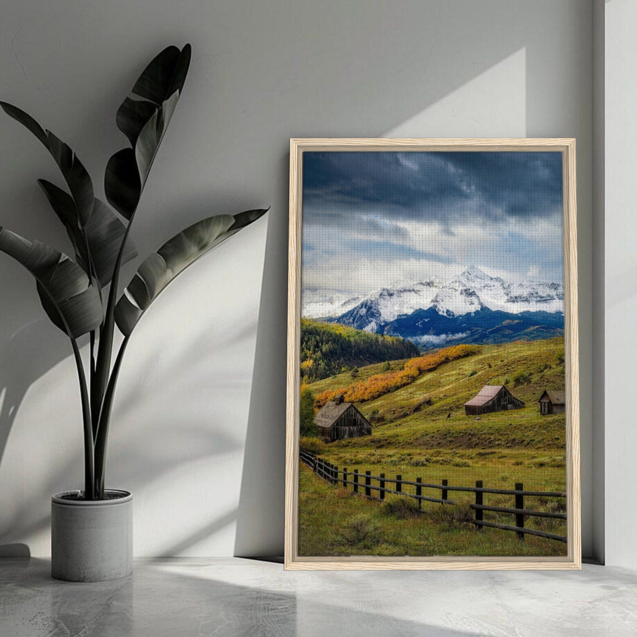 Framed canvas print of Telluride, Colorado, showcasing snow-capped mountains and rustic barns in a serene valley.