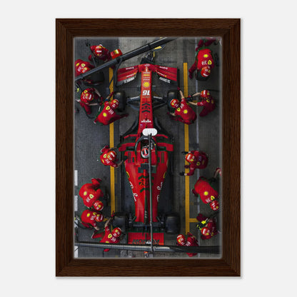 Framed canvas print of a Ferrari Formula 1 pitstop, showcasing vibrant colors and dynamic motorsport action.