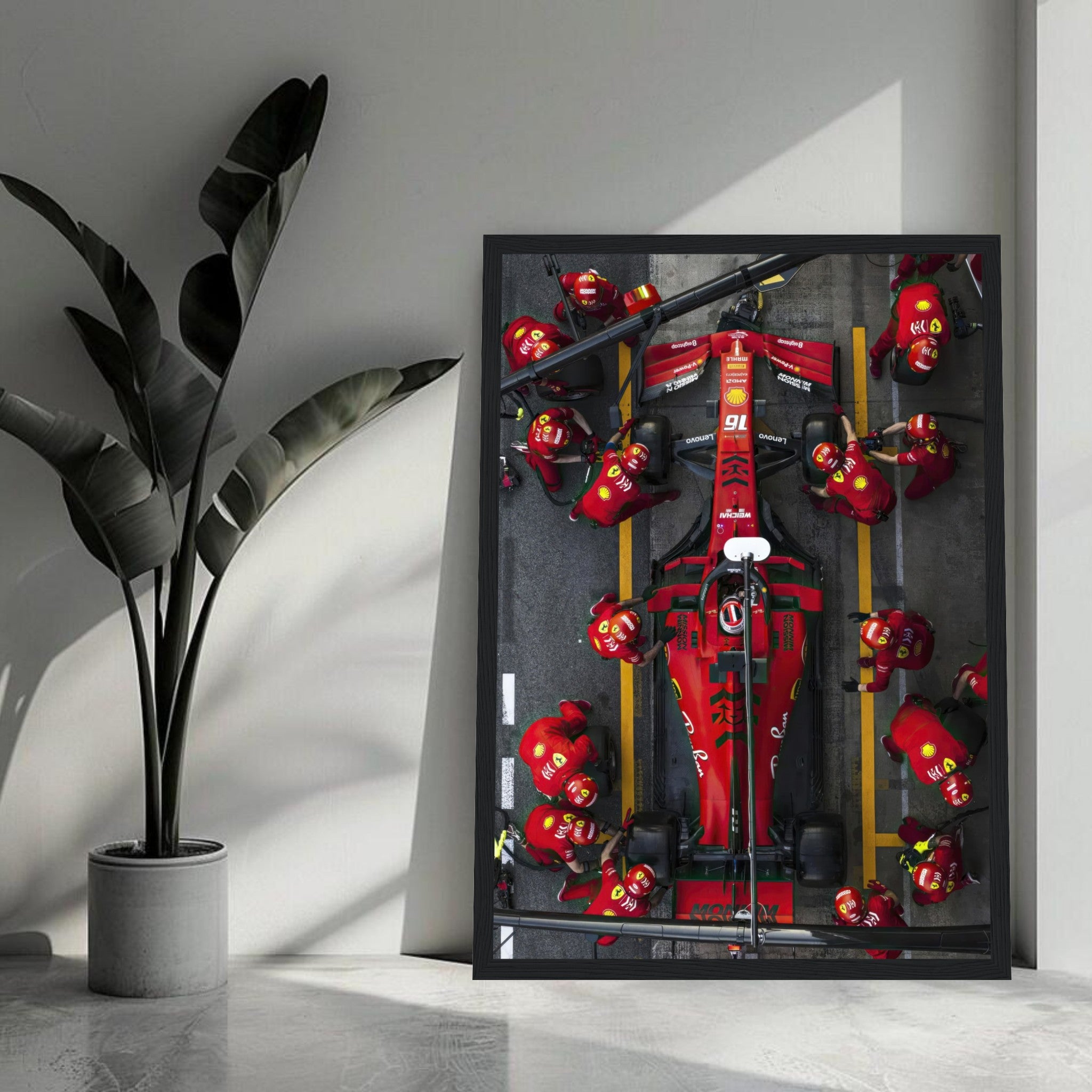 Framed print of a Ferrari F1 pitstop, showcasing a dynamic pit crew in action, perfect for motorsport enthusiasts.