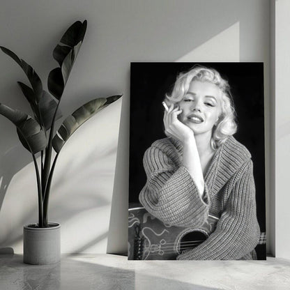 Marilyn Monroe smoking while dressed in a cozy sweater, captured in black and white on a stylish metal print.