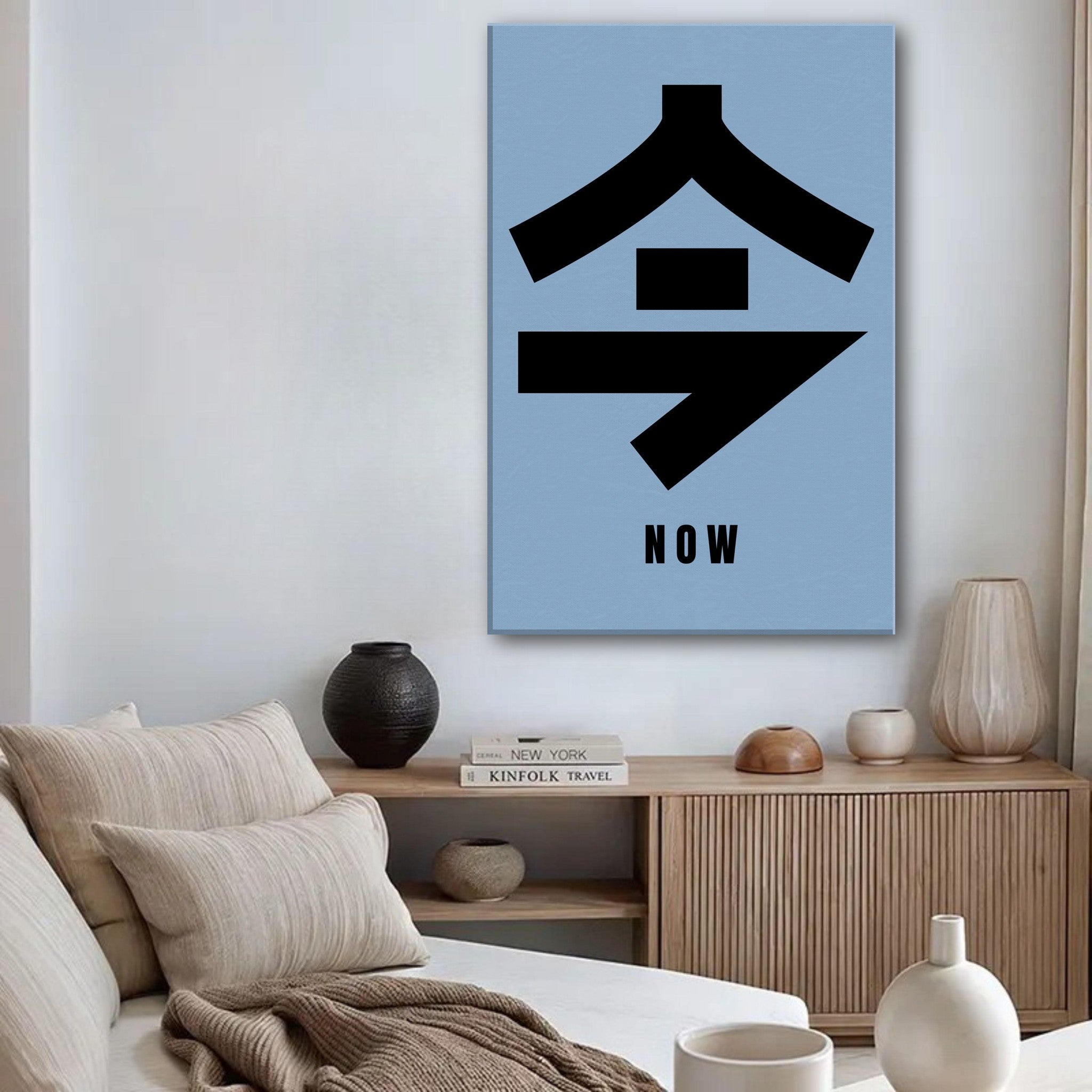 Now in Japanese Kanji canvas print with bold black typography on a soft blue background, adding elegance to any space.