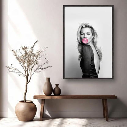 Vintage framed print of a woman blowing bubble gum in black-and-white, adding modern elegance to home decor.