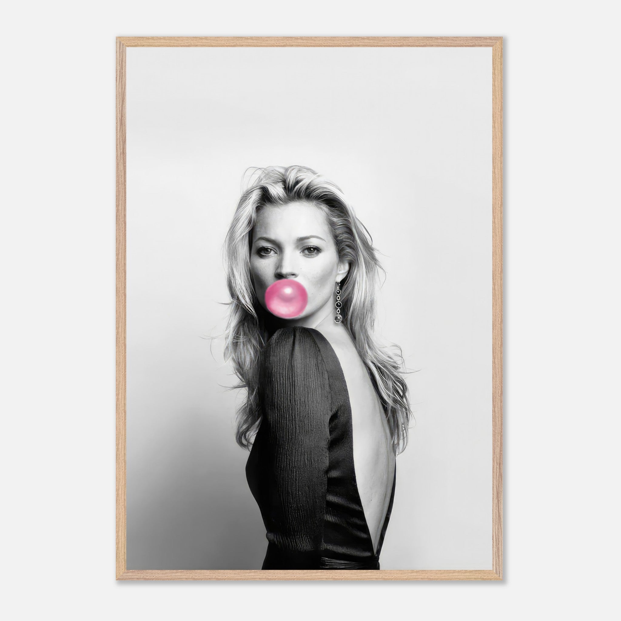 Kate Moss vintage portrait with pink bubble gum in sleek black frame, showcasing timeless fashion photography.