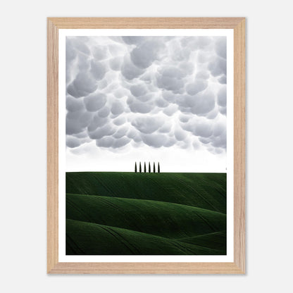 Toscana vintage framed art featuring cypress trees against green hills and a dramatic cloudy sky.