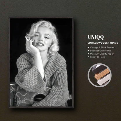 Vintage framed print of Marilyn Monroe elegantly posing with a guitar, showcasing timeless Hollywood glamour.