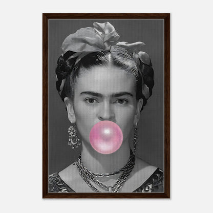 Frida Kahlo bubbles gum in grayscale portrait framed in natural wood, adding playful vintage charm to any space.