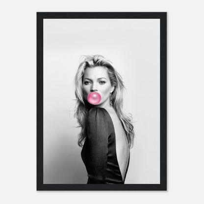 Framed print of Kate Moss blowing bubble gum in a chic black-and-white portrait with pink accent.