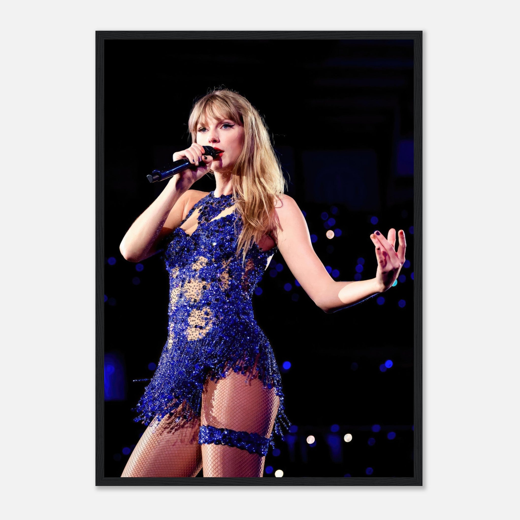 Taylor Swift performing in a dazzling blue ensemble, captured in a framed print showcasing her dynamic stage presence.