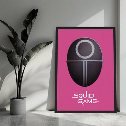 Squid Game Guard Mask framed print on a pink background, perfect wall art for fans of the Netflix series.