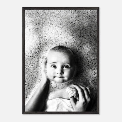 Baby bath vintage framed print featuring a joyful baby surrounded by bubbles in a serene black and white scene.