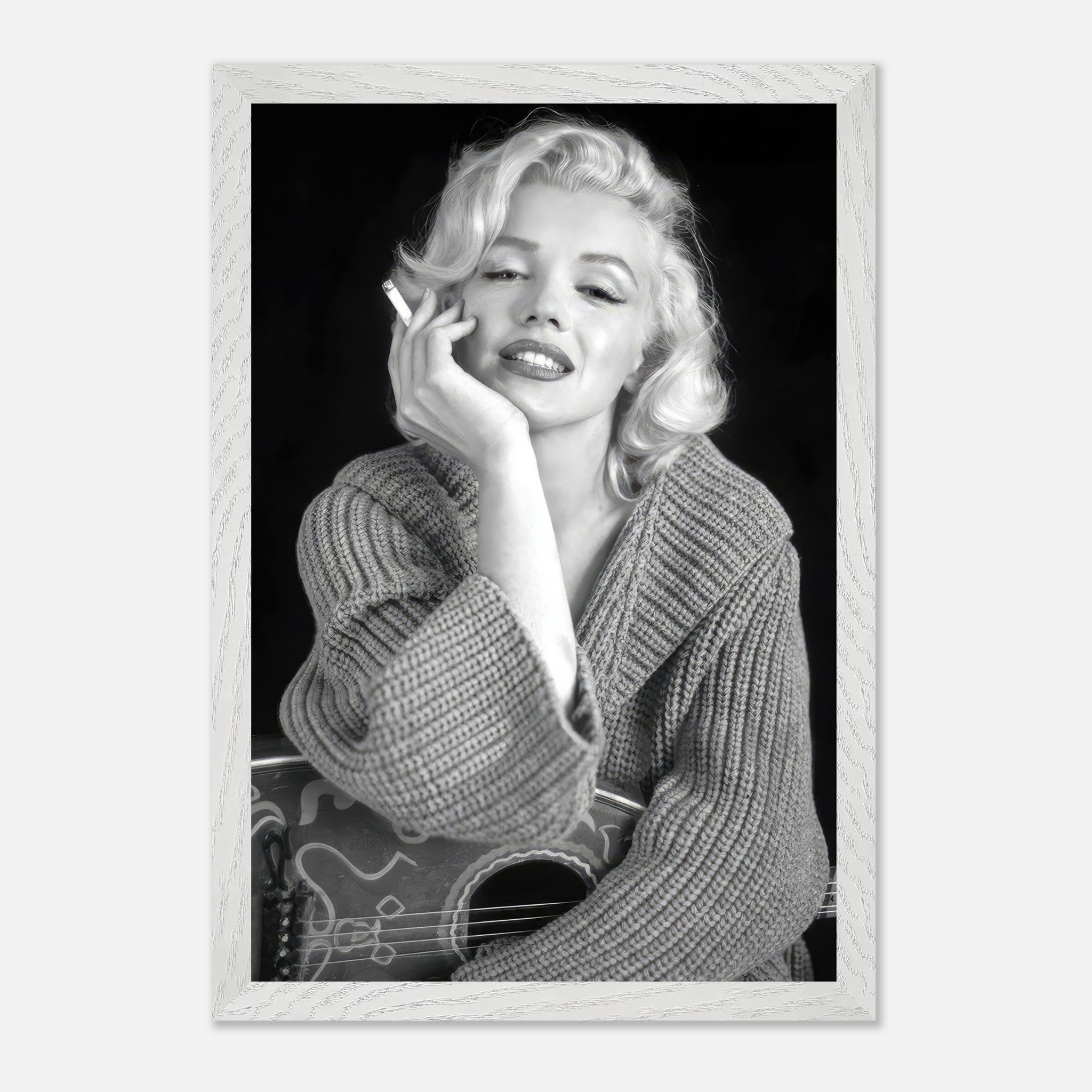 Marilyn Monroe smoking in a cozy sweater, captured in a vintage black-and-white framed print. Classic Hollywood elegance.