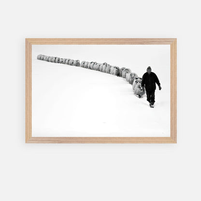 The Shepherd's Trail fine art print featuring a shepherd guiding his flock in a snowy landscape.