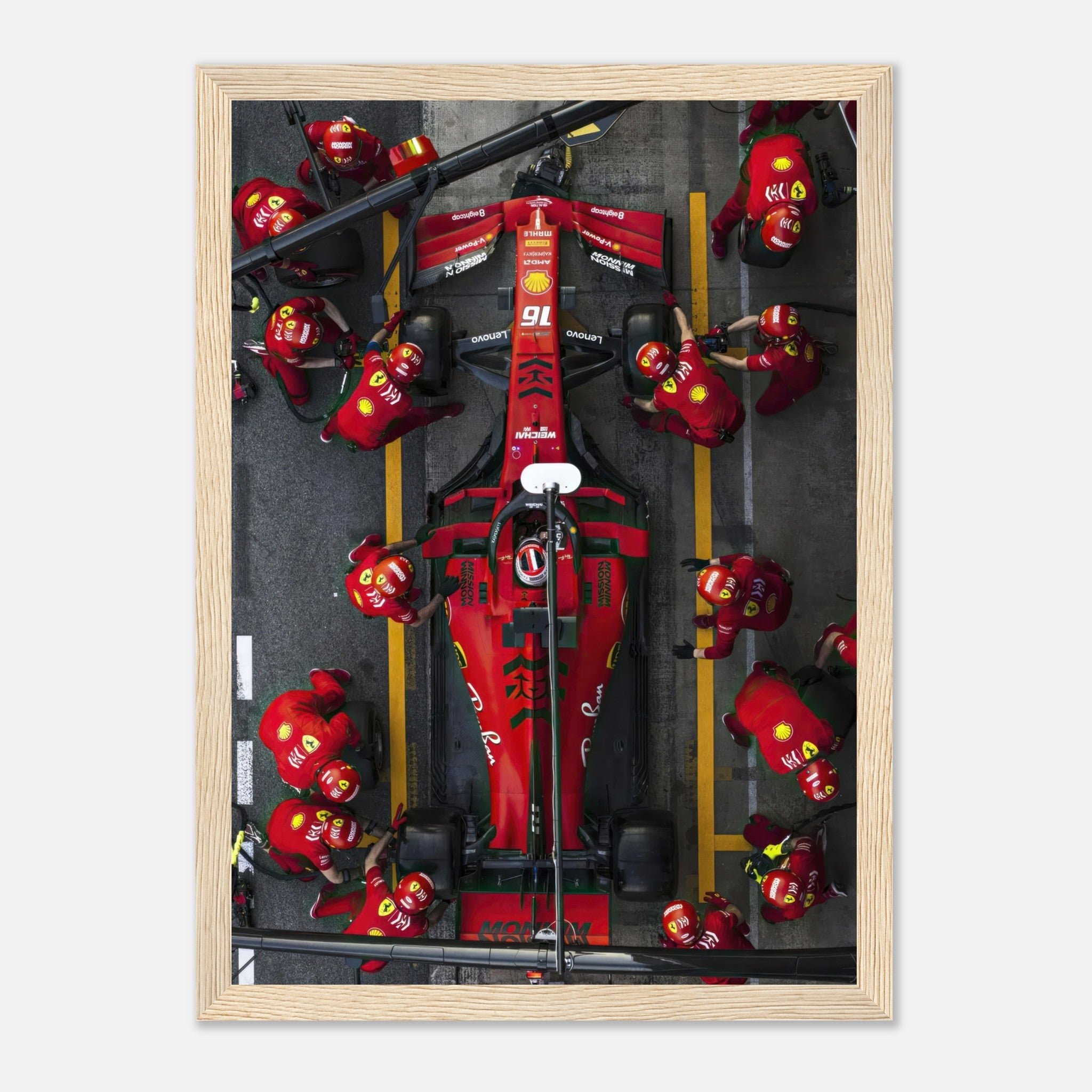 Framed print of a thrilling Ferrari Formula 1 pitstop, showcasing the intense action and precision of the pit crew.