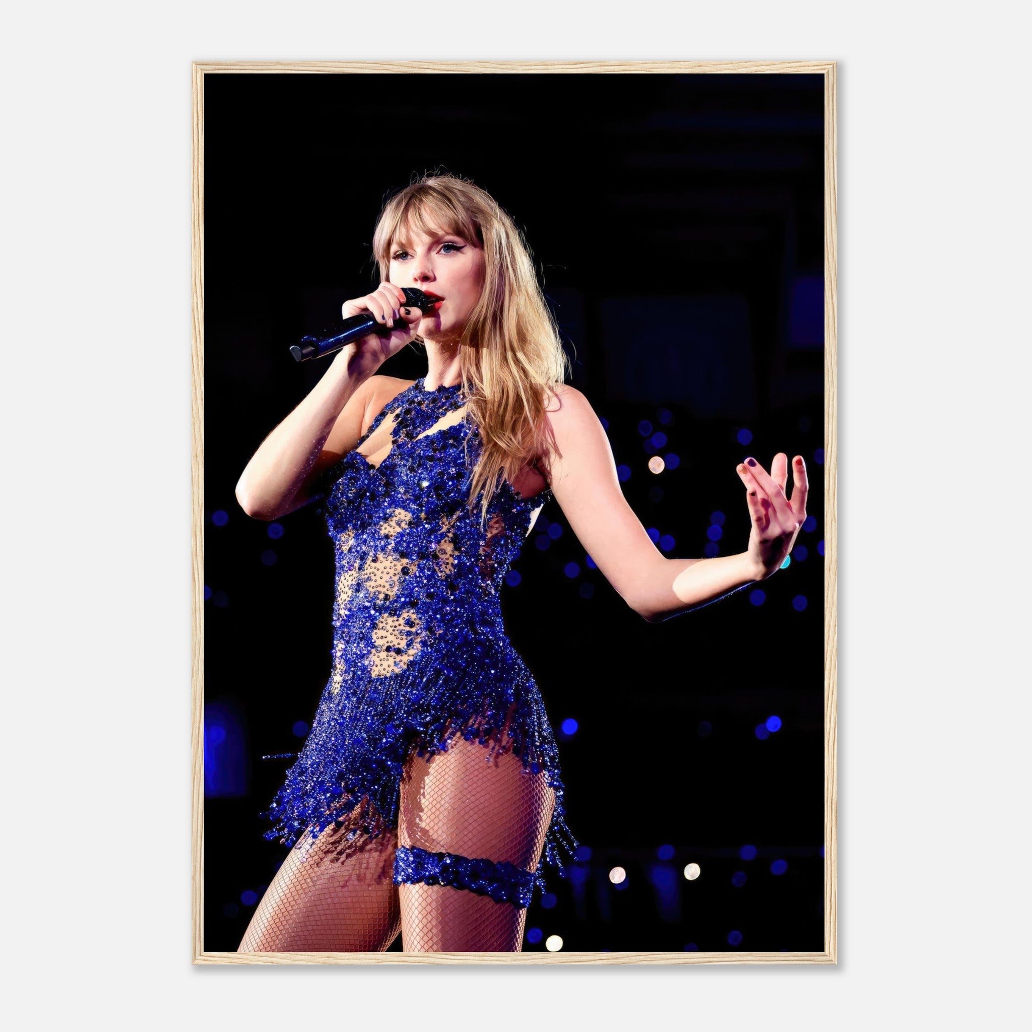 Taylor Swift performing in a dazzling blue outfit, captured in a stunning framed print, perfect for fans and music lovers.