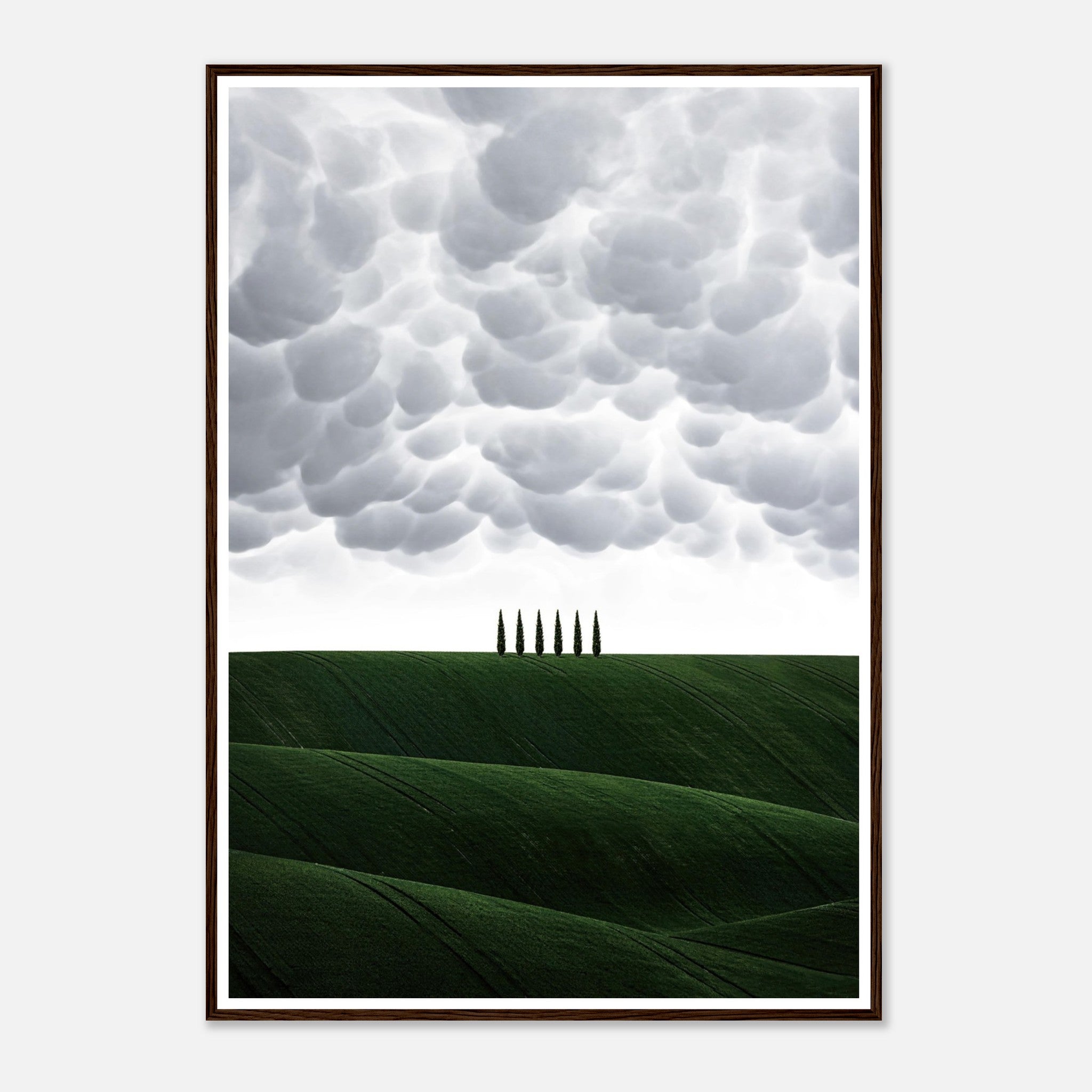 Toscana Italy framed print featuring rolling green hills and cypress trees under dramatic clouds.