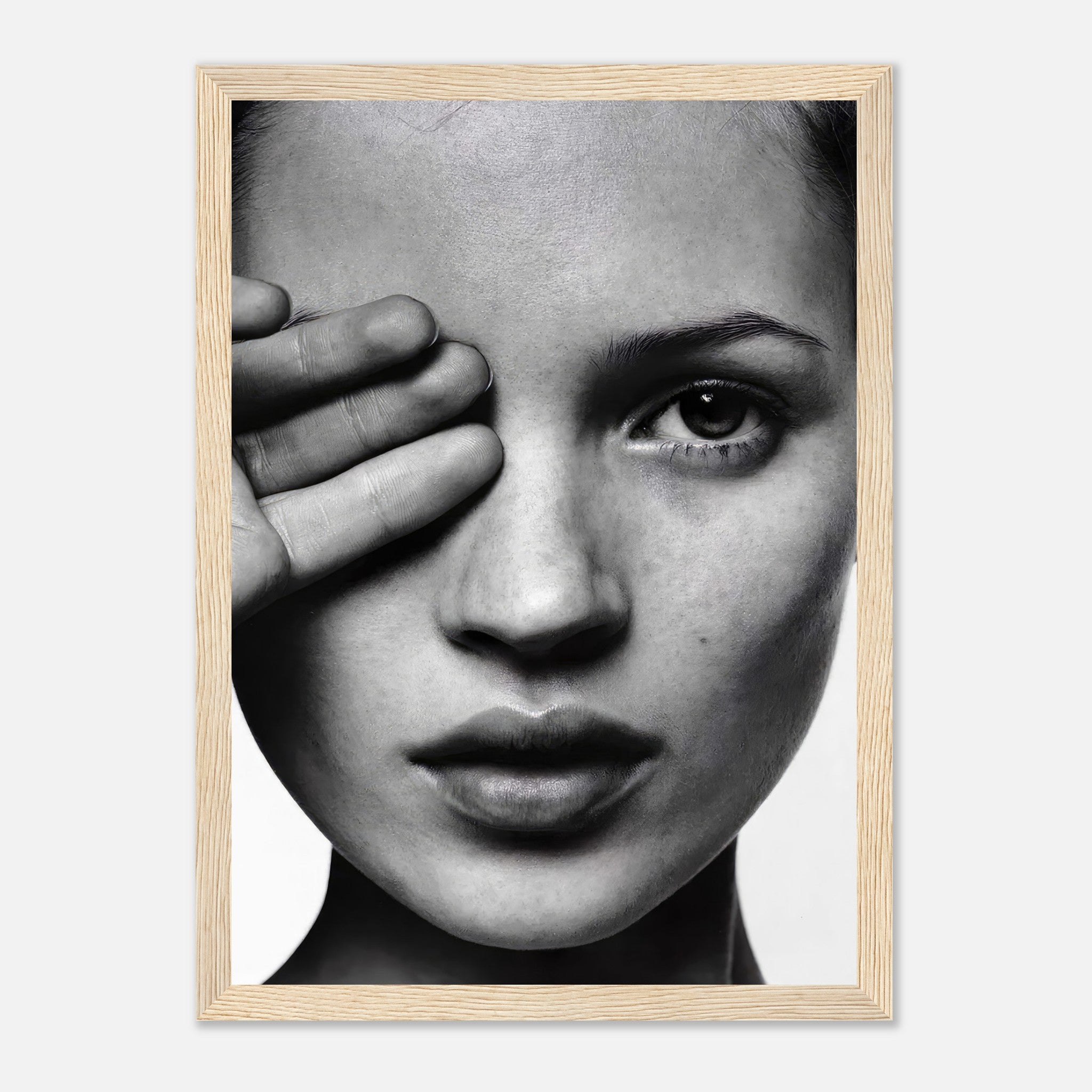 Kate Moss black and white framed print showcasing a striking portrait with hand over eye, highlighting modern elegance.