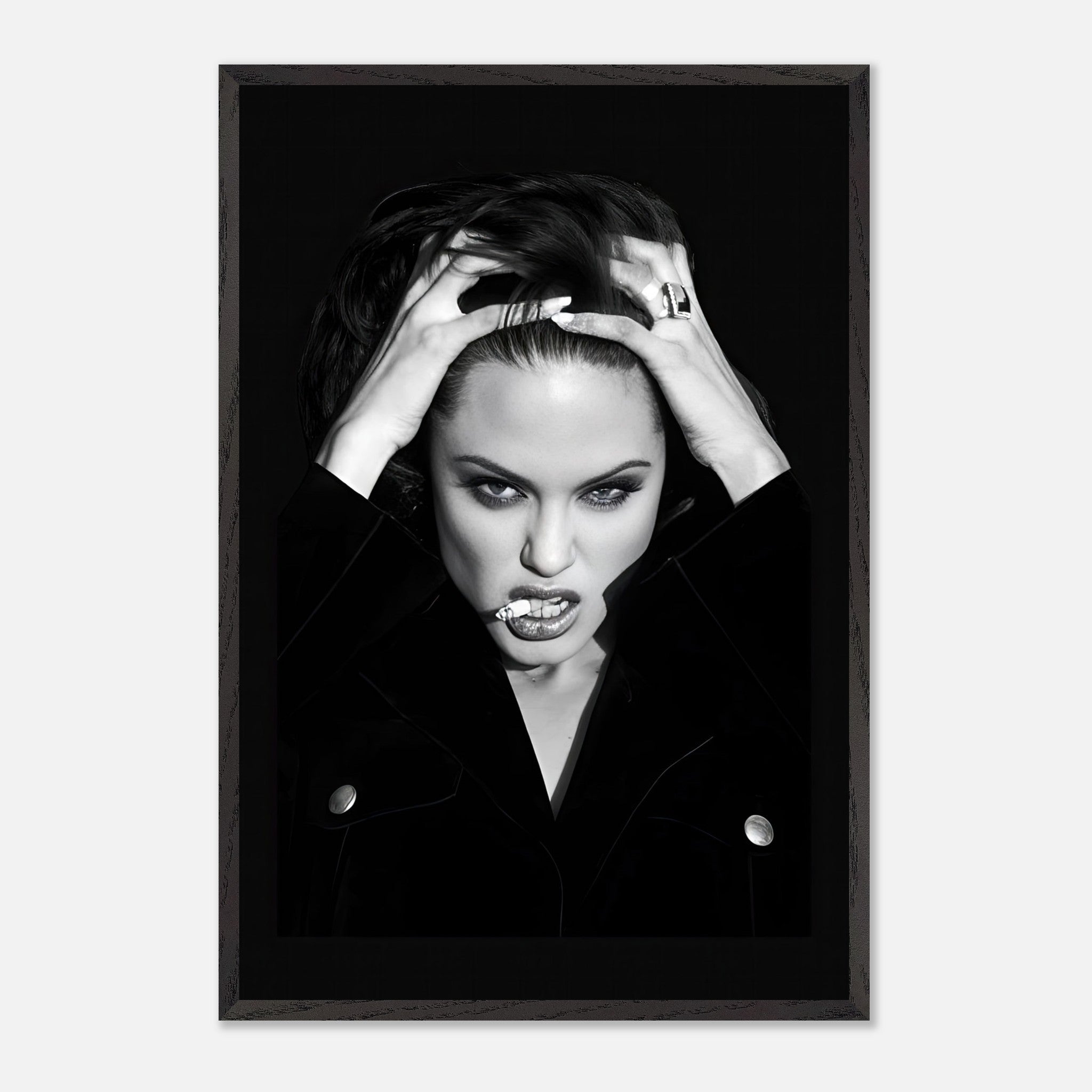 Black-and-white vintage framed print of Angelina Jolie with a bold expression and striking pose.