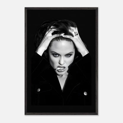 Black-and-white vintage framed print of Angelina Jolie with a bold expression and striking pose.