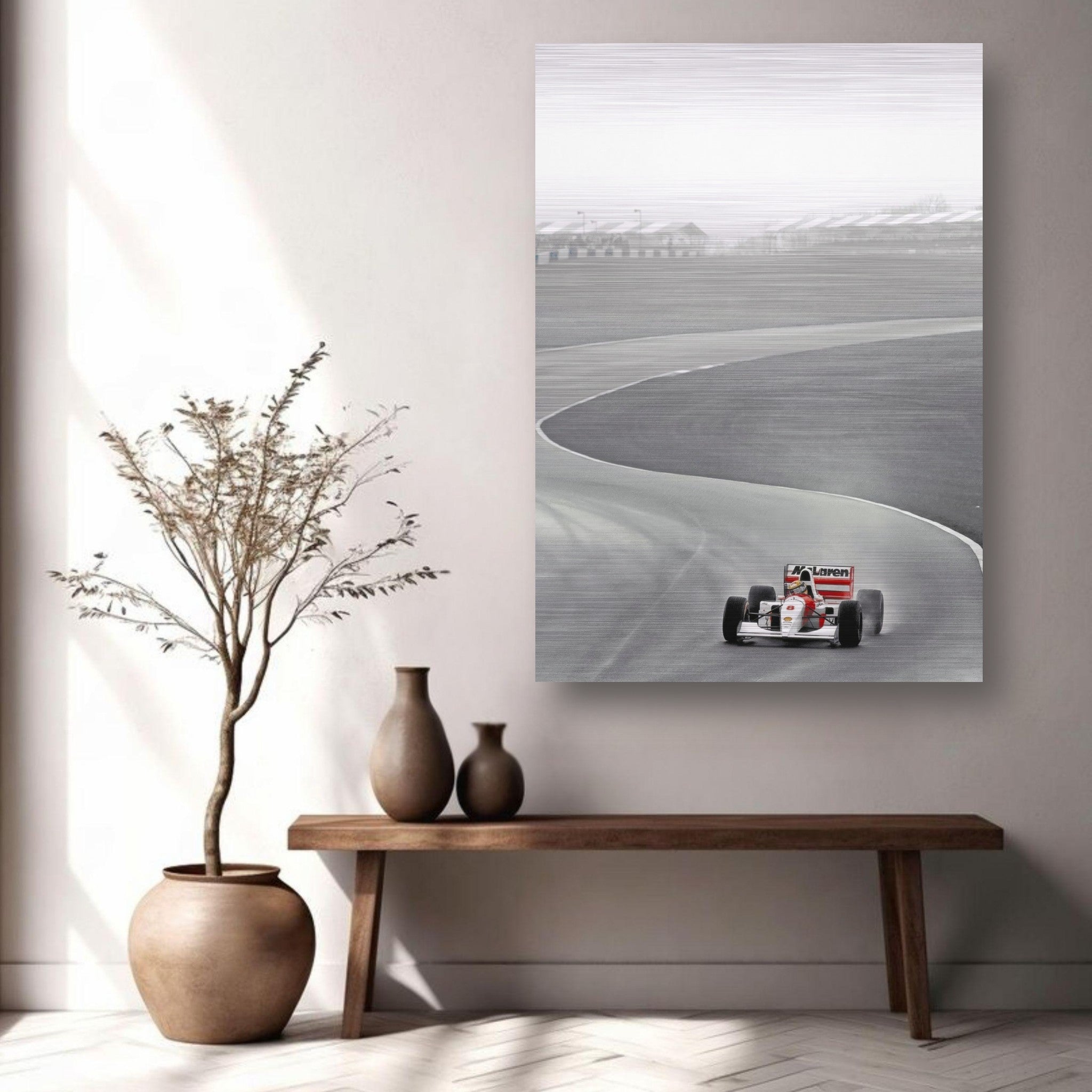 Ayrton Senna in a McLaren racing on a track, displayed on brushed metal artwork in a stylish interior setting.