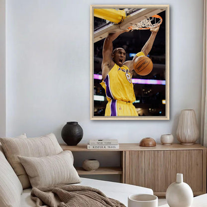 Kobe Bryant's slam dunk framed canvas print, showcasing his iconic basketball moment in a stylish interior.