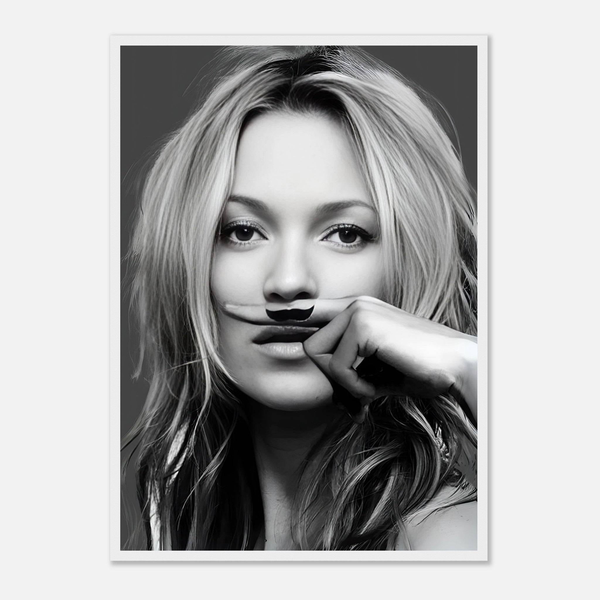 Black-and-white portrait of a woman humorously holding a mustache, showcasing playful elegance in a framed print.