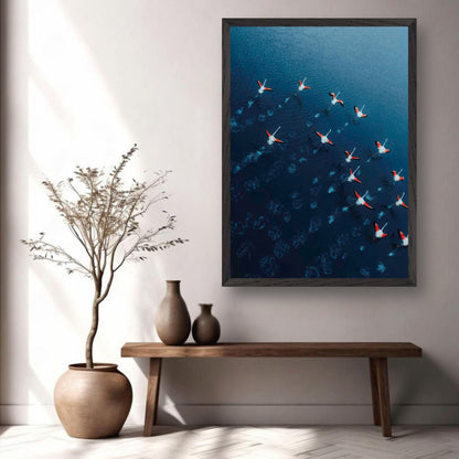 Flamingos aerial photography print in a modern living room, showcasing vibrant pink birds over deep blue water.