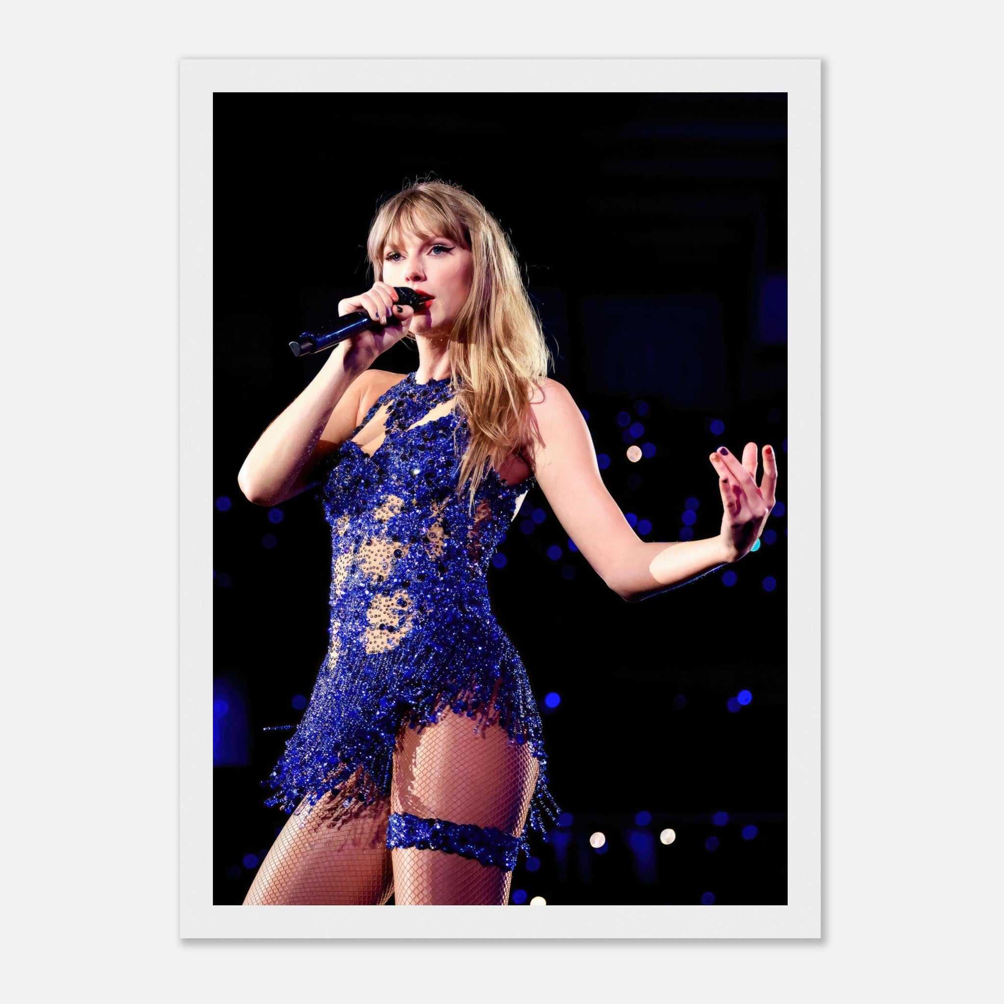 Taylor Swift performing in a dazzling blue outfit, captured in a high-resolution framed print for fans.