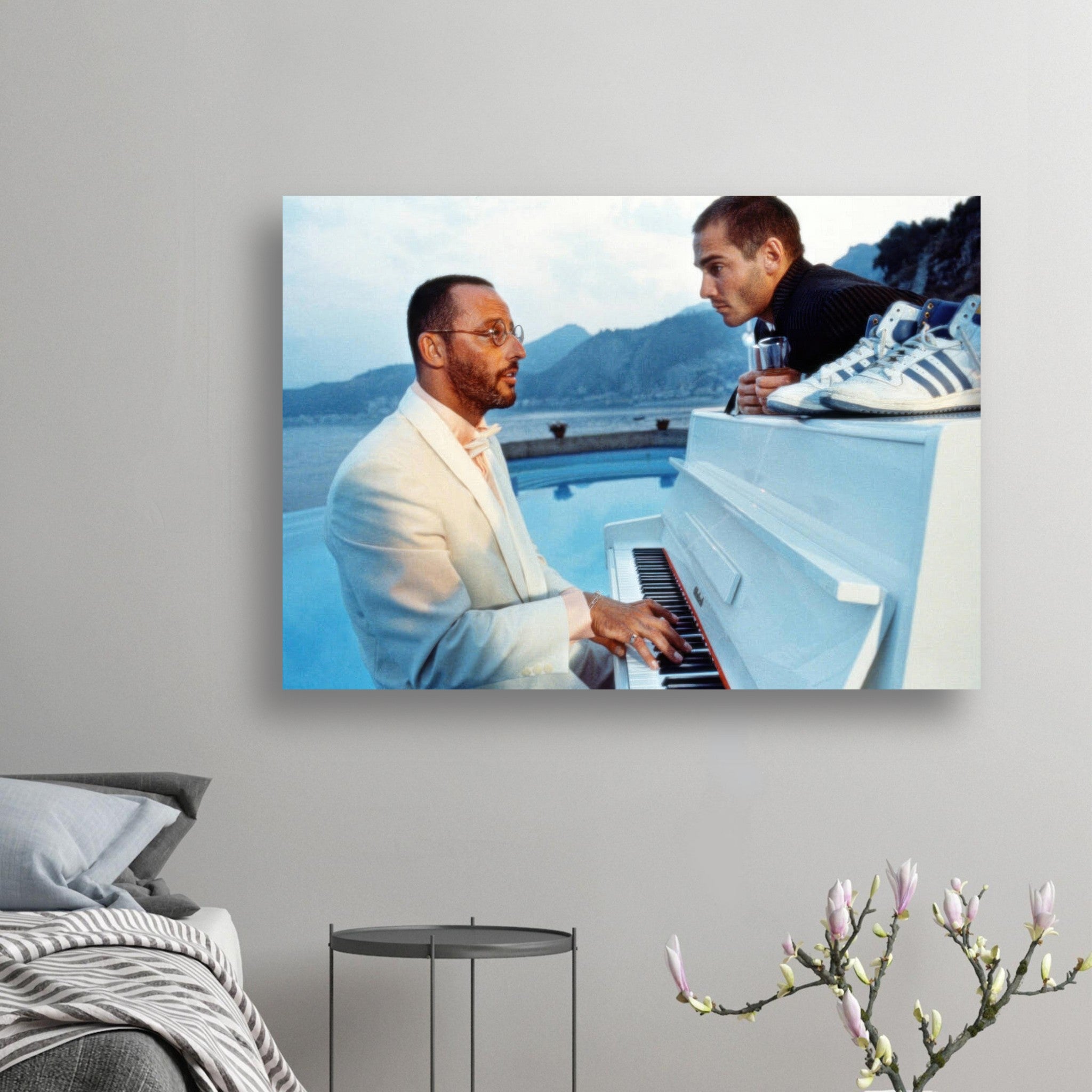 Jean Reno playing a sleek white piano outdoors with scenic coastal view, capturing a moment of artistic elegance.