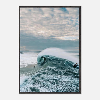 Big Wave Surfing Vintage Framed Print featuring a surfer riding a massive wave under a moody sky.
