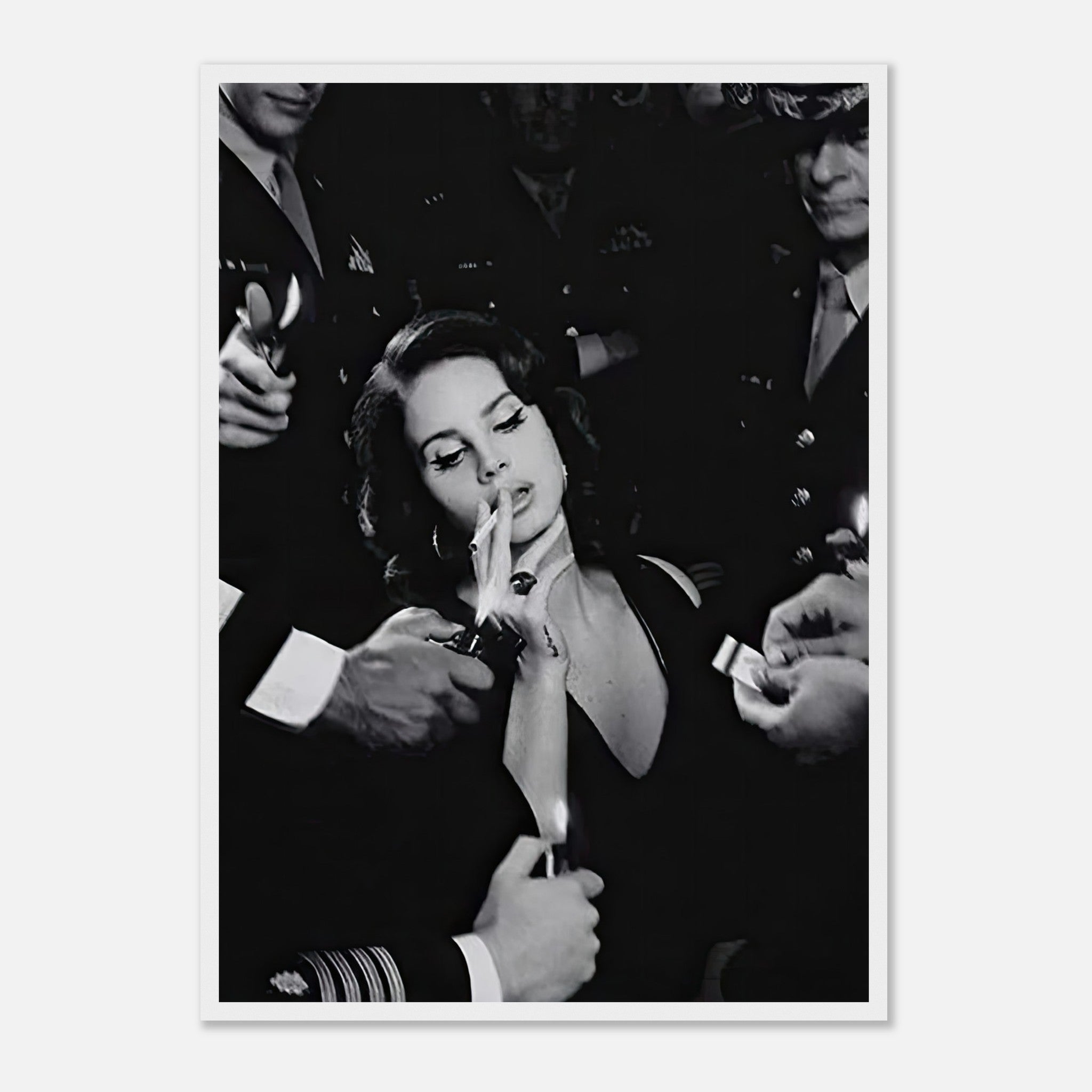 Lana Del Ray smoking in black-and-white, surrounded by admirers, showcasing a vintage Hollywood aesthetic.