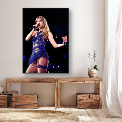 Framed print of Taylor Swift performing in a stunning blue outfit, showcasing her stage presence and vibrant energy.