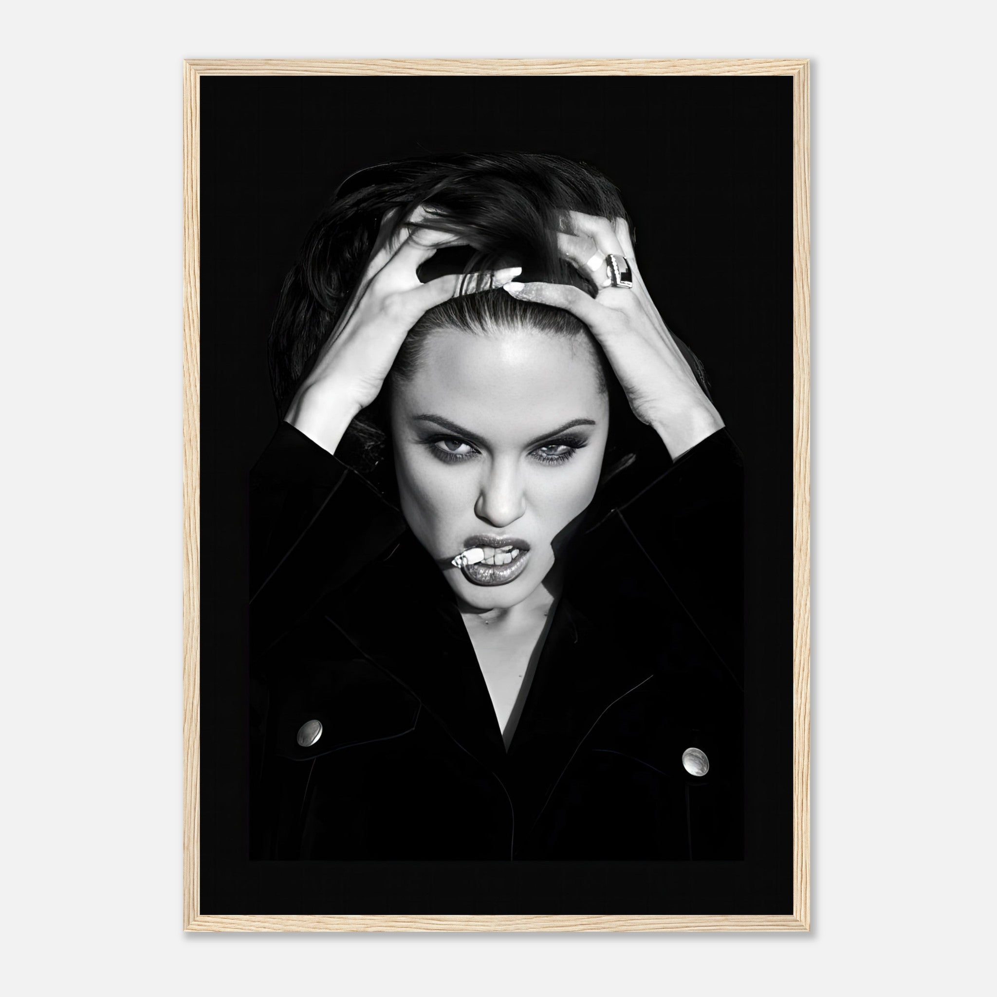 Black-and-white framed print of a fierce woman with hands in hair, showcasing bold glamour and dramatic contrast.