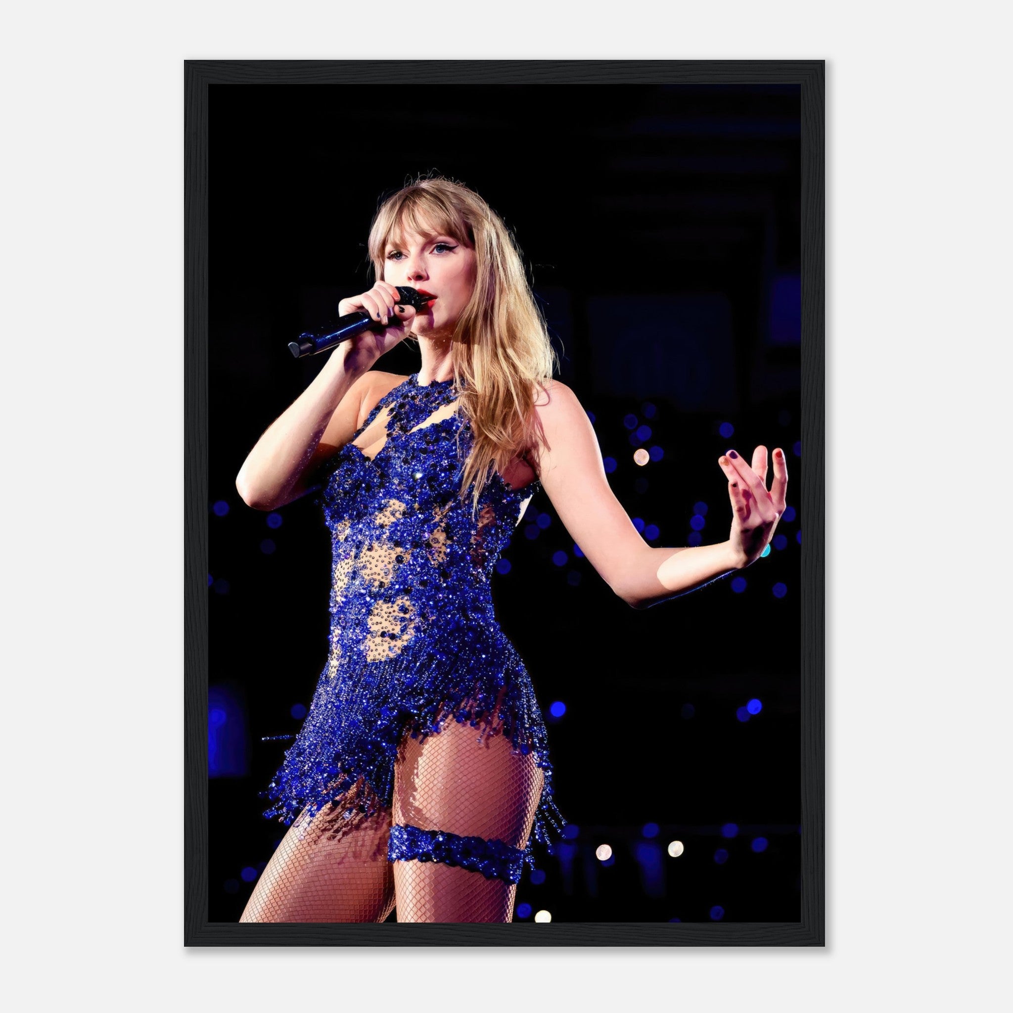 Taylor Swift performing in a dazzling blue outfit, captured in a vibrant framed print for fans and collectors.